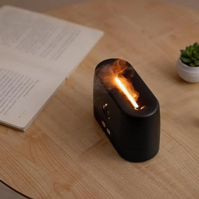 Tradeo flame diffuser with glowing mist on a desk