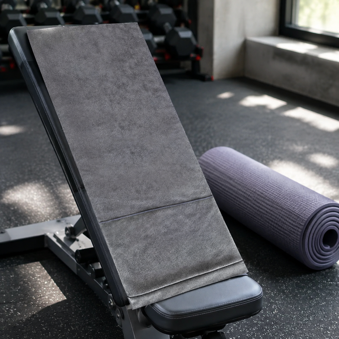 Grey microfiber sports towel on a gym bench